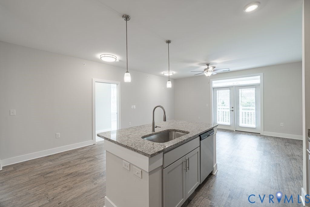 10530 Stony Bluff Drive, #102, Stony Run Condos, Ashland, VA 23005 Kitchen island with granite countertop, integrated sink, and stainless steel dishwasher