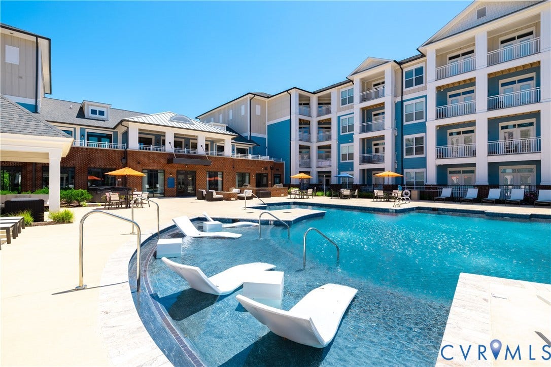 10530 Stony Bluff Drive, #102, Stony Run Condos, Ashland, VA 23005 Outdoor swimming pool with integrated lounge seating, surrounded by a light-colored concrete deck