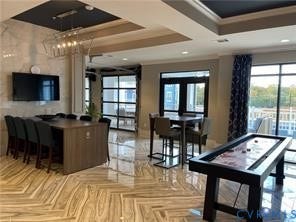 10530 Stony Bluff Drive, #102, Stony Run Condos, Ashland, VA 23005 Glossy tile flooring, tray ceiling with recessed lighting, full-height windows, and a glass-paneled door