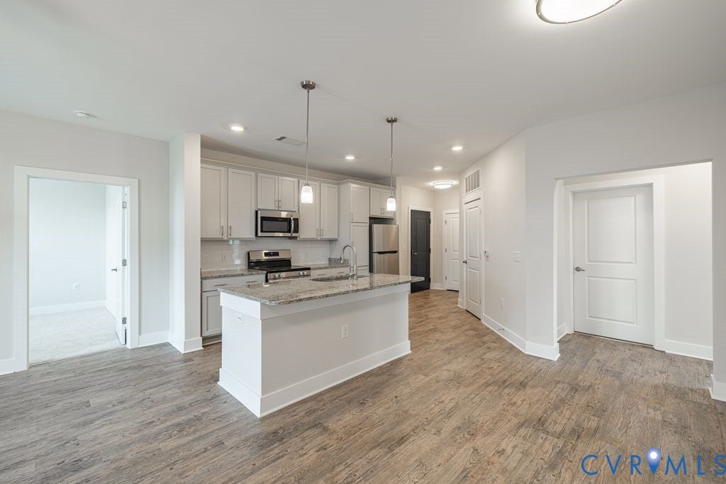 10530 Stony Bluff Drive, #102, Stony Run Condos, Ashland, VA 23005 Kitchen island with pendant lighting, stainless steel appliances, light-toned cabinetry, wood-finish flooring, and recessed lighting