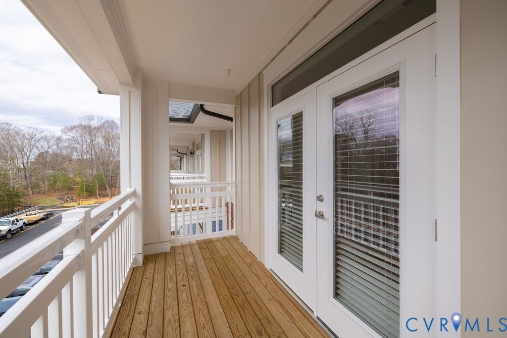 10530 Stony Bluff Drive, #102, Stony Run Condos, Ashland, VA 23005 Outdoor balcony featuring wood-finish flooring, white railing, and double French doors with integrated blinds