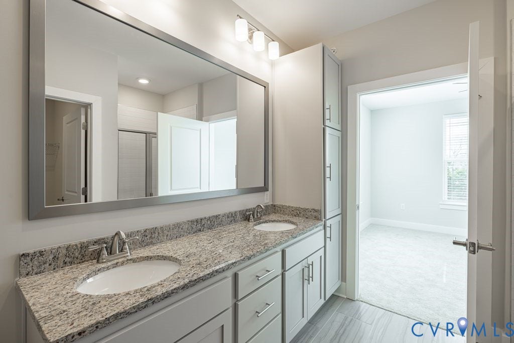 10530 Stony Bluff Drive, #102, Stony Run Condos, Ashland, VA 23005 Dual vanity with light-toned cabinetry, granite countertop, and integrated sinks