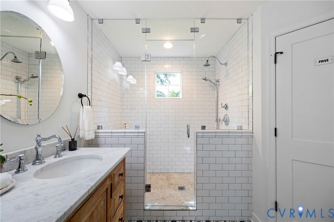 4919 Park Avenue, Near West End, Richmond, VA 23226 White subway tile shower with glass enclosure, dual showerheads, and a mosaic tile floor