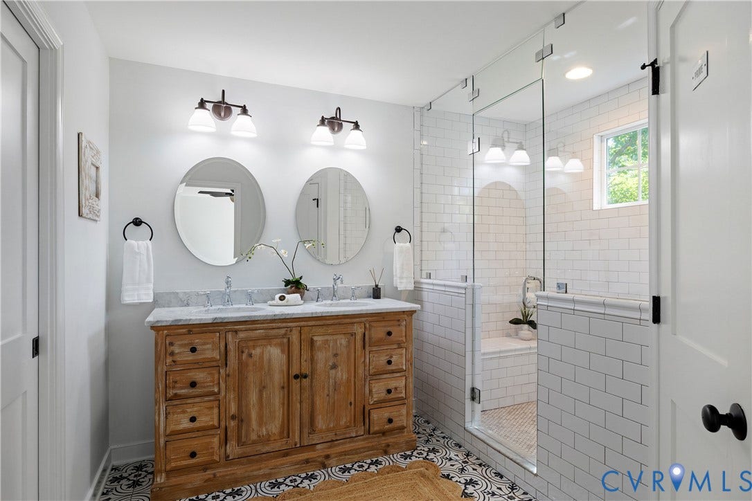 4919 Park Avenue, Near West End, Richmond, VA 23226 Double vanity with a light-toned wood finish and a stone countertop