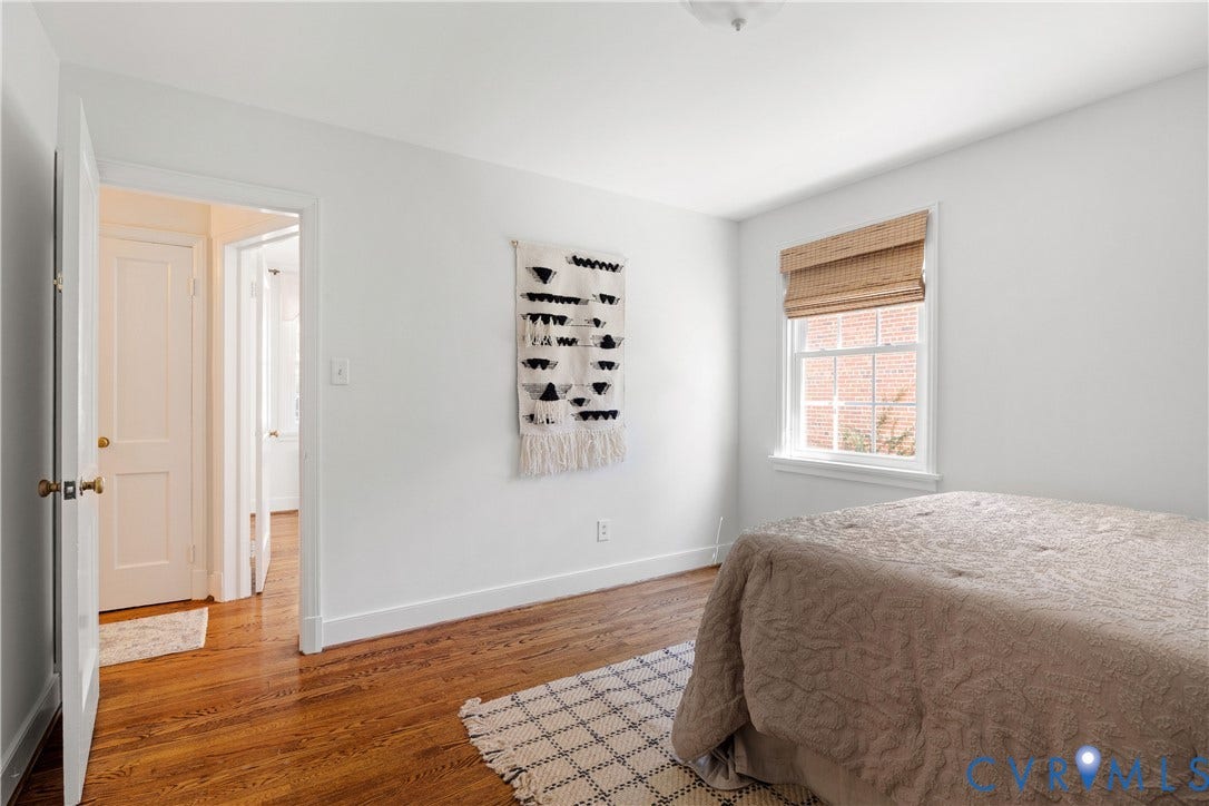 4919 Park Avenue, Near West End, Richmond, VA 23226 Hardwood flooring, white painted walls, white trim, recessed lighting, and a window with a woven shade