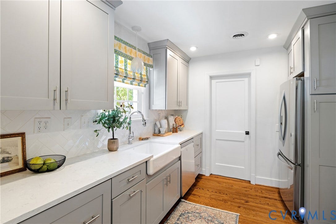 4919 Park Avenue, Near West End, Richmond, VA 23226 Wood-finish flooring, white countertops, farmhouse sink, stainless steel appliances, and recessed lighting