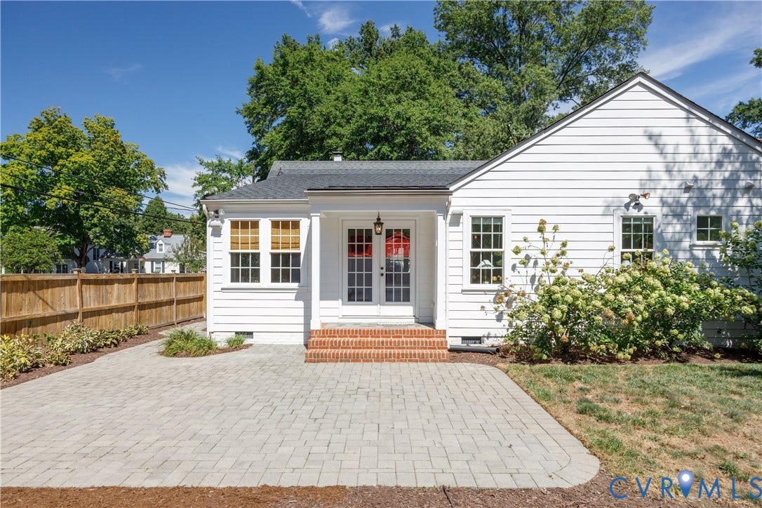 4919 Park Avenue, Near West End, Richmond, VA 23226 White siding exterior with multiple windows, a wood privacy fence, and a paver patio