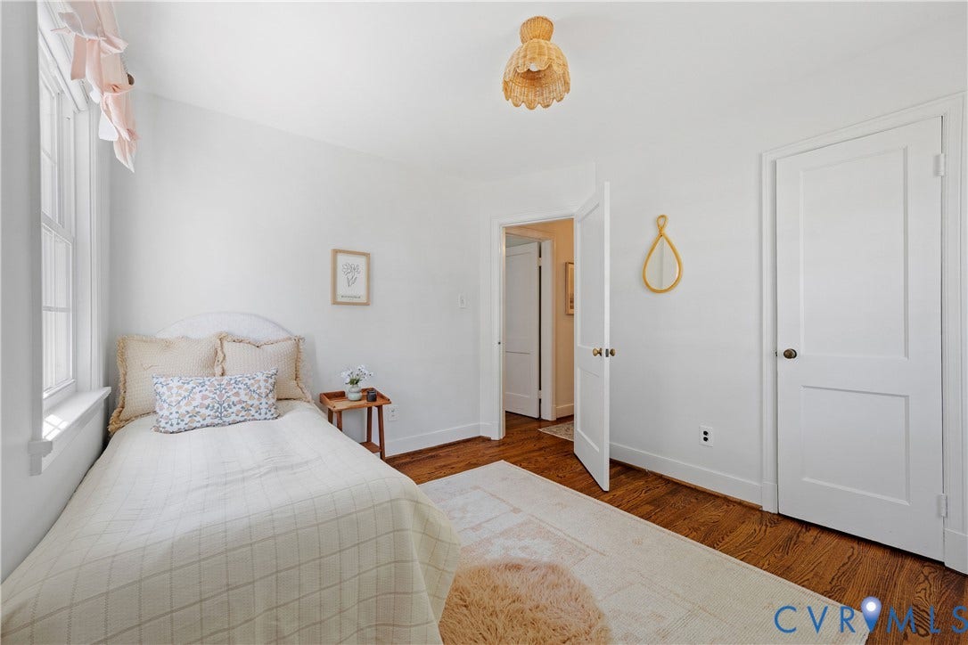 4919 Park Avenue, Near West End, Richmond, VA 23226 Hardwood flooring, white painted walls, white trim, white panel doors, and a decorative ceiling fixture