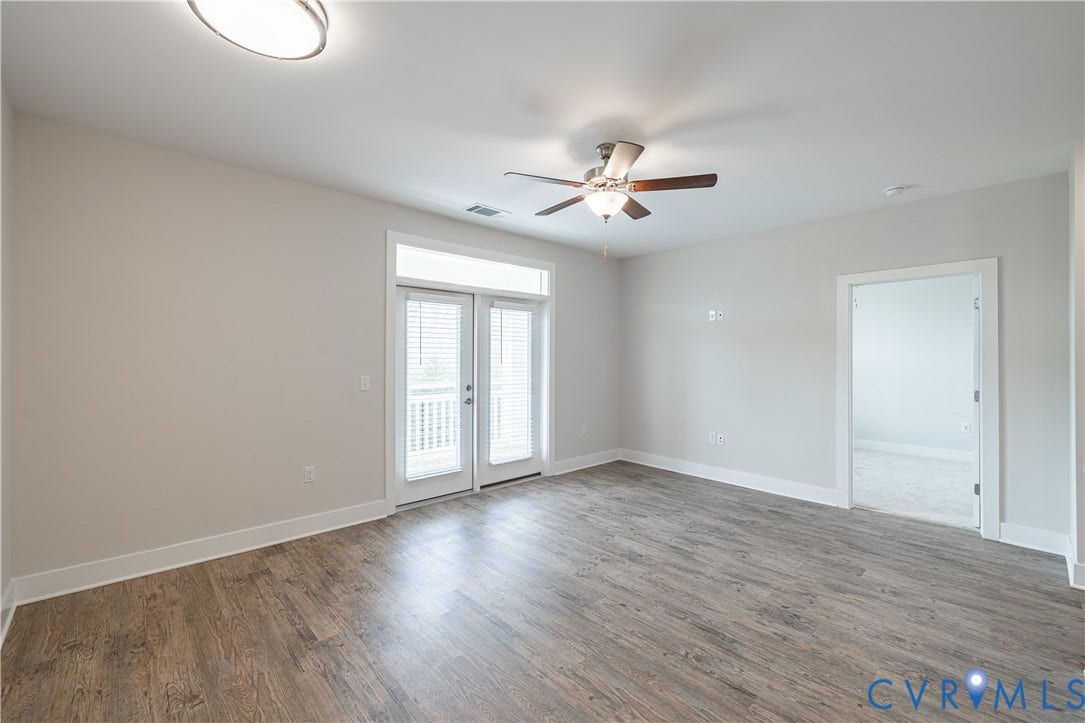 10526 Stony Bluff Drive, #302, Stony Run Condos, Ashland, VA 23005 Wood-finish flooring, white walls, double French doors, ceiling fan, and recessed lighting
