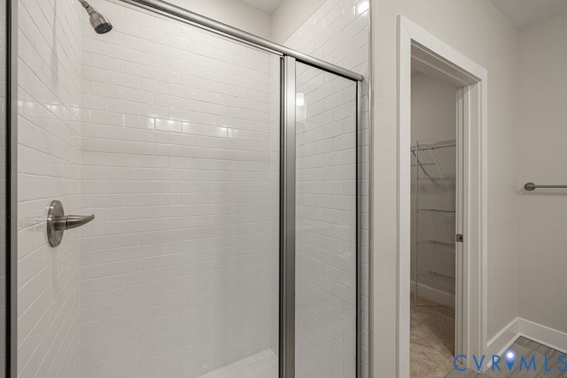 10526 Stony Bluff Drive, #302, Stony Run Condos, Ashland, VA 23005 Shower with subway tile surround, glass enclosure, and brushed nickel fixtures