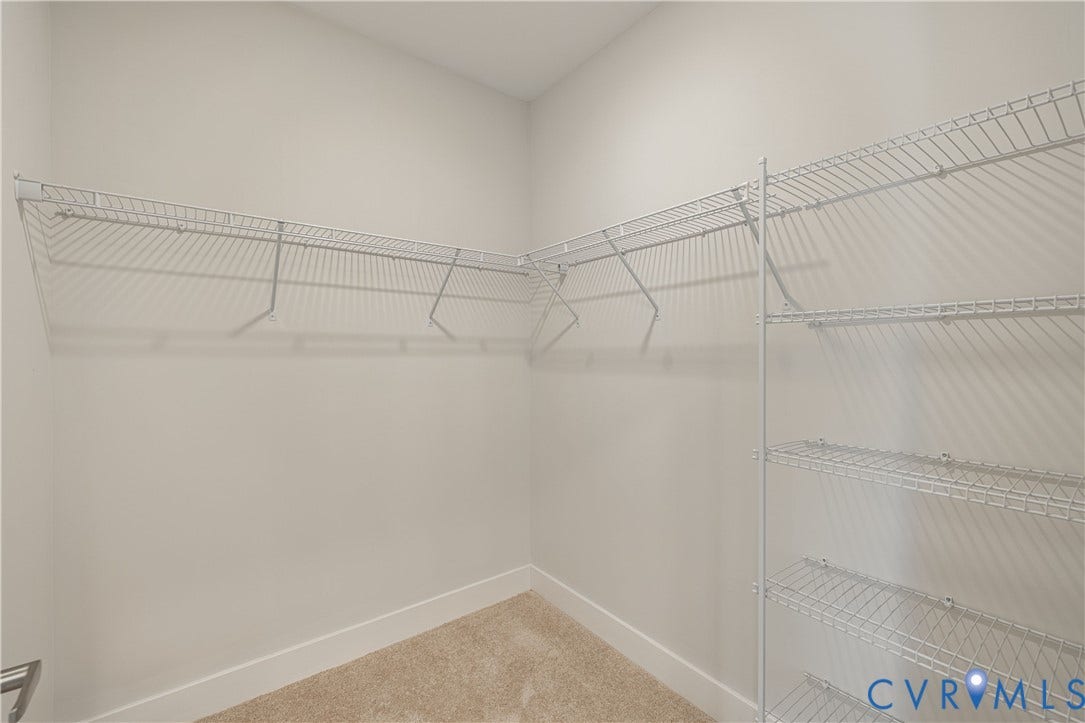 10526 Stony Bluff Drive, #302, Stony Run Condos, Ashland, VA 23005 Walk-in closet with wire shelving system, wire hanging rods, and light-toned carpet flooring