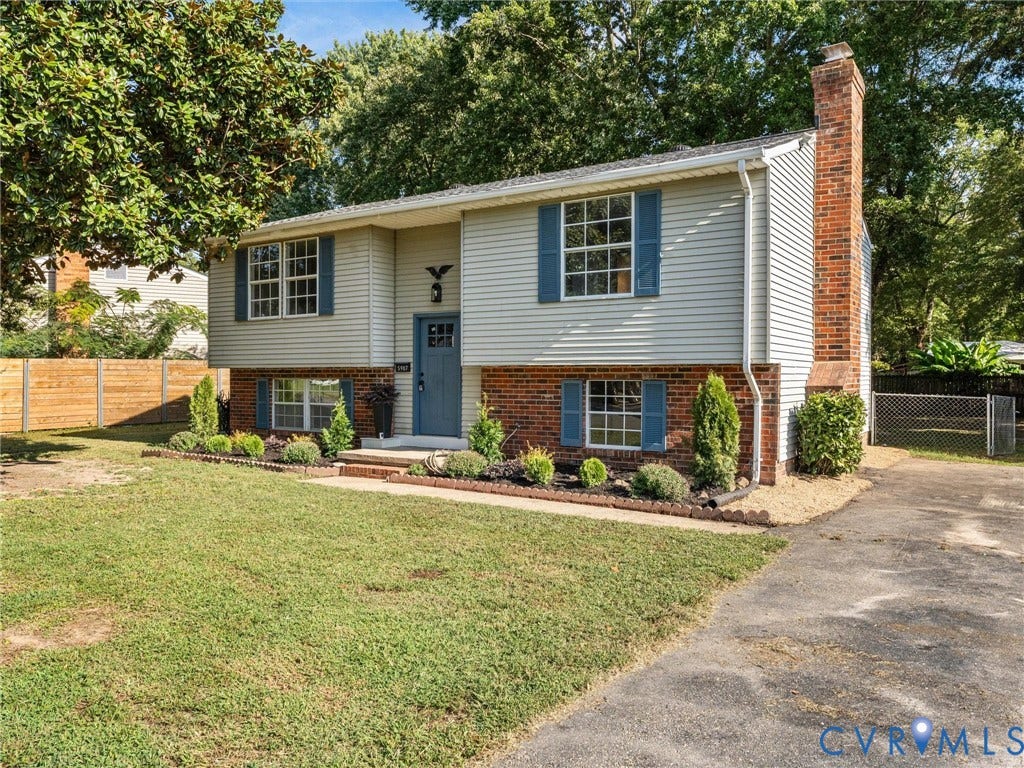 5907 Stella Road, Richmond, VA 23234 Split-level residence featuring light-colored siding and brick facade