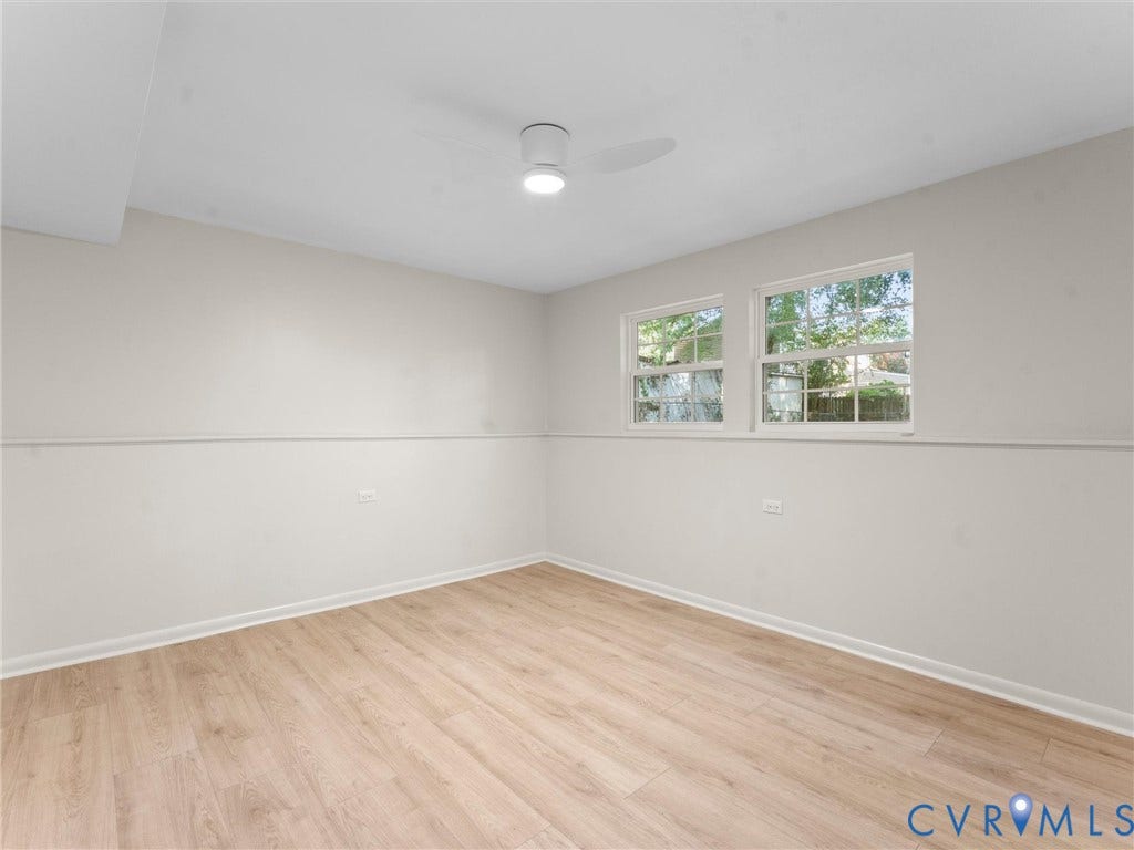 5907 Stella Road, Richmond, VA 23234 Wood-finish flooring, two large windows with natural light, a ceiling-mounted light fixture, and neutral wall tones