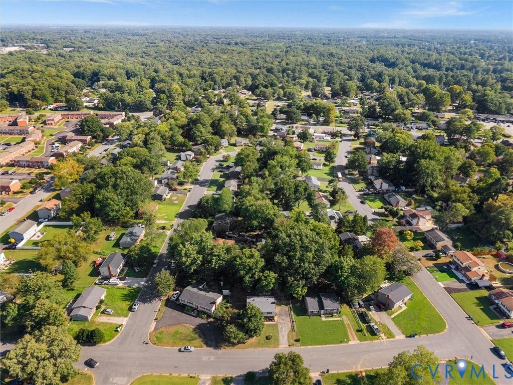 5907 Stella Road, Richmond, VA 23234 Residential neighborhood with mature trees and a clear sky backdrop