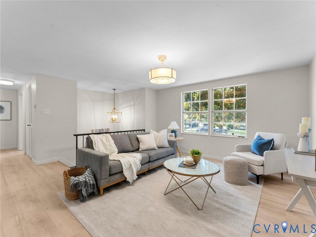 5907 Stella Road, Richmond, VA 23234 Light wood-finish flooring, dual windows with grid panes, a drum-style ceiling fixture, and a black metal railing
