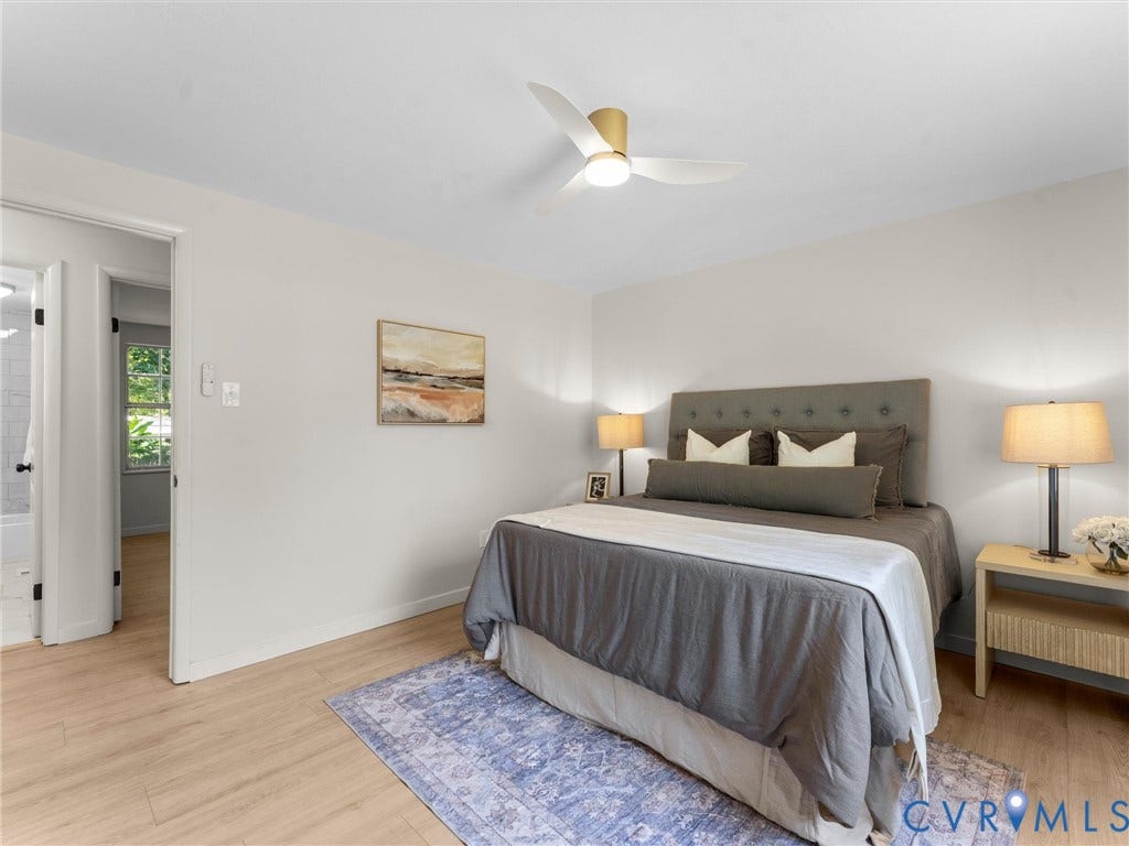 5907 Stella Road, Richmond, VA 23234 Light-toned wood-finish flooring, a contemporary ceiling fan with integrated lighting, and a neutral color palette