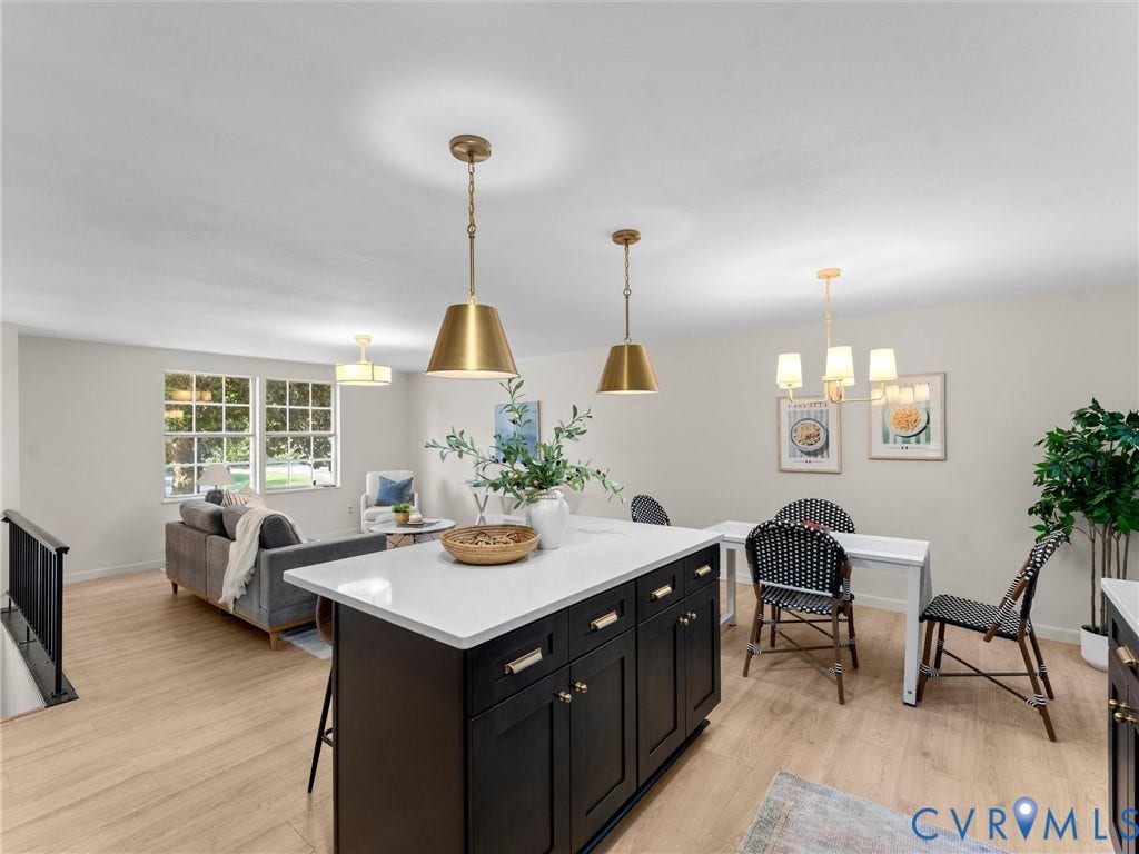 5907 Stella Road, Richmond, VA 23234 Open-concept living area featuring light wood-finish flooring, white walls, and multiple windows