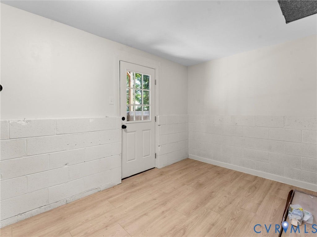 5907 Stella Road, Richmond, VA 23234 Wood-finish flooring with white painted walls and a block foundation wall