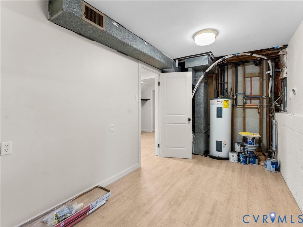 5907 Stella Road, Richmond, VA 23234 Light-toned wood-finish flooring, white painted walls, and a ceiling-mounted light fixture