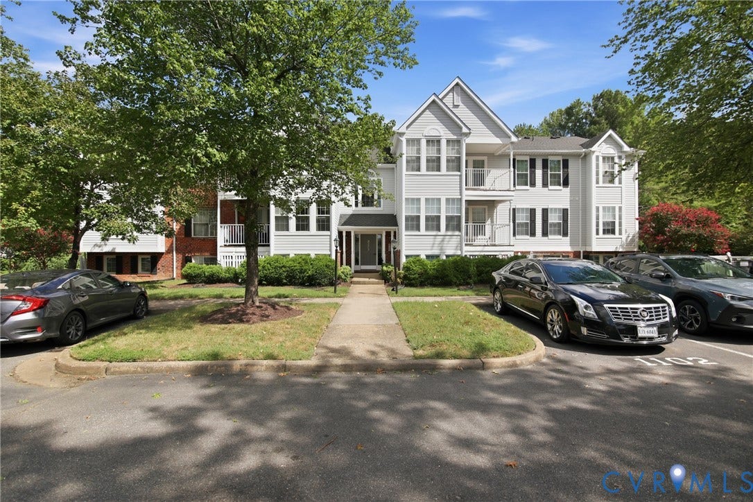Three-story 12-unit building. Unit 1112 is on the 3rd level, in rear of the property with a view of the wooded green space from the balcony.