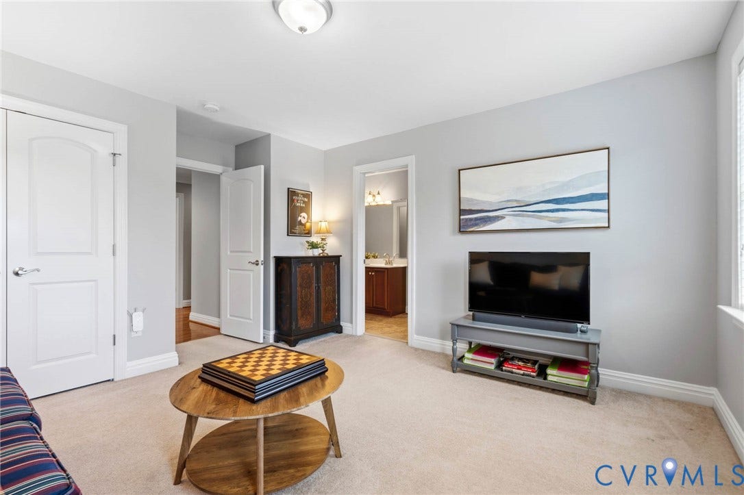 Plush carpet flooring, light gray wall paint, and white trim throughout