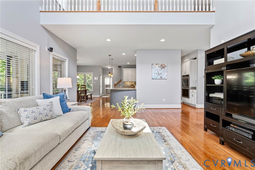 Hardwood-finish flooring, recessed lighting, and a two-story ceiling