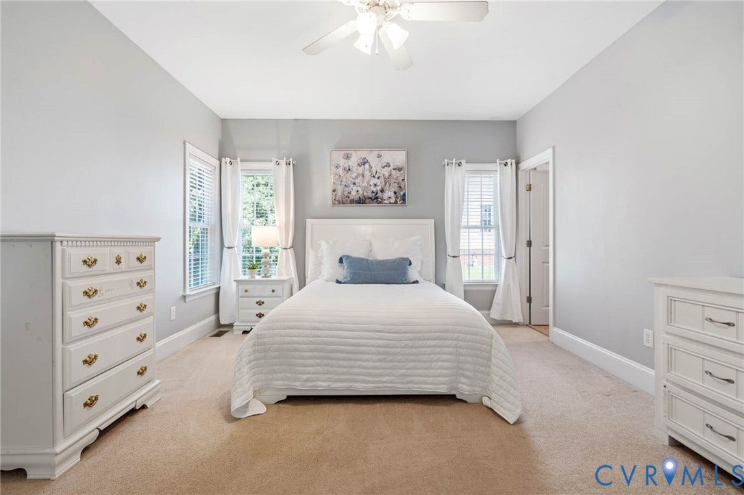 First Floor Bedroom with a ceiling fan, multiple windows, and ensuite to Full Bathroom