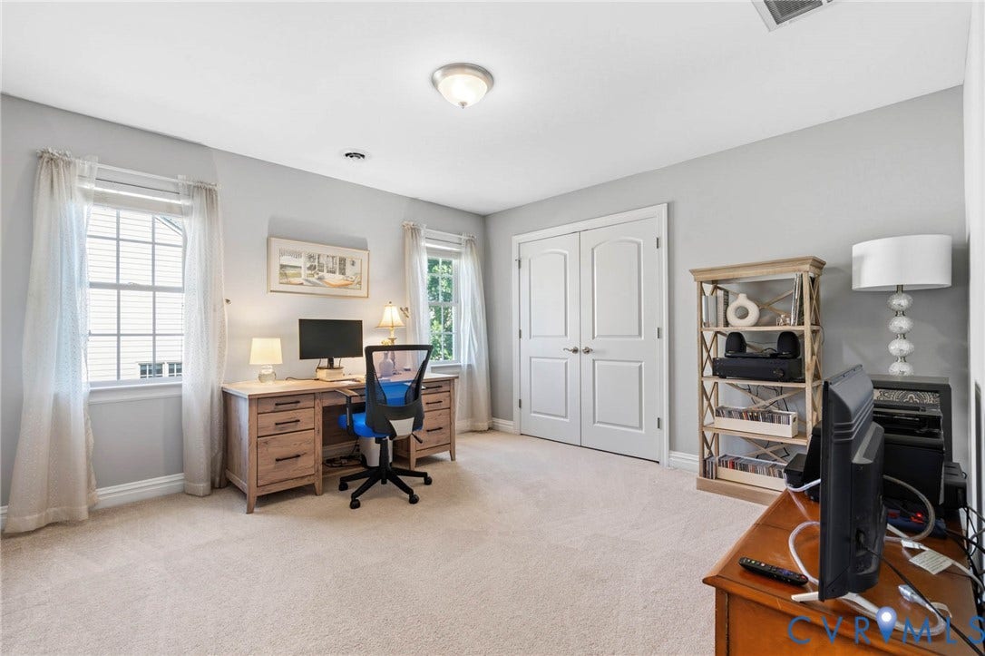 Wall-to-wall carpeting with light gray walls, white trim, and dual windows