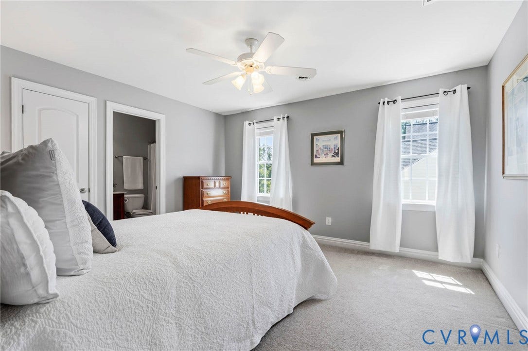Recessed panel interior doors, carpet flooring, ceiling fan, and multiple windows