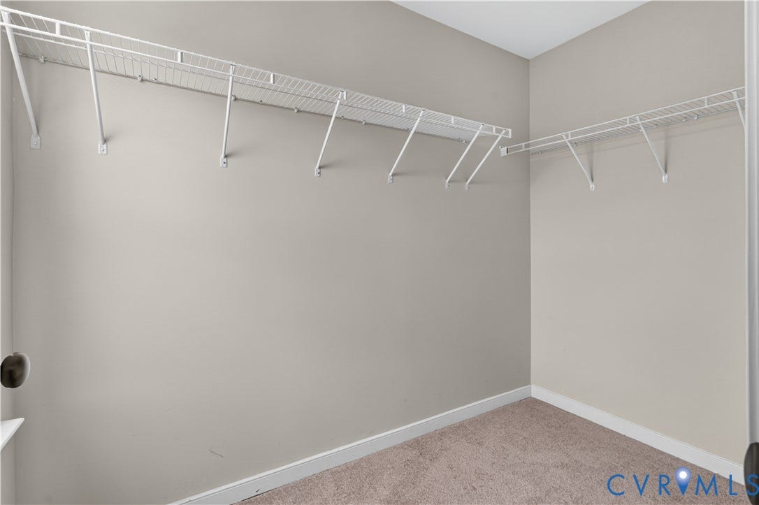 Corner storage shelving system with white wire racks and support brackets