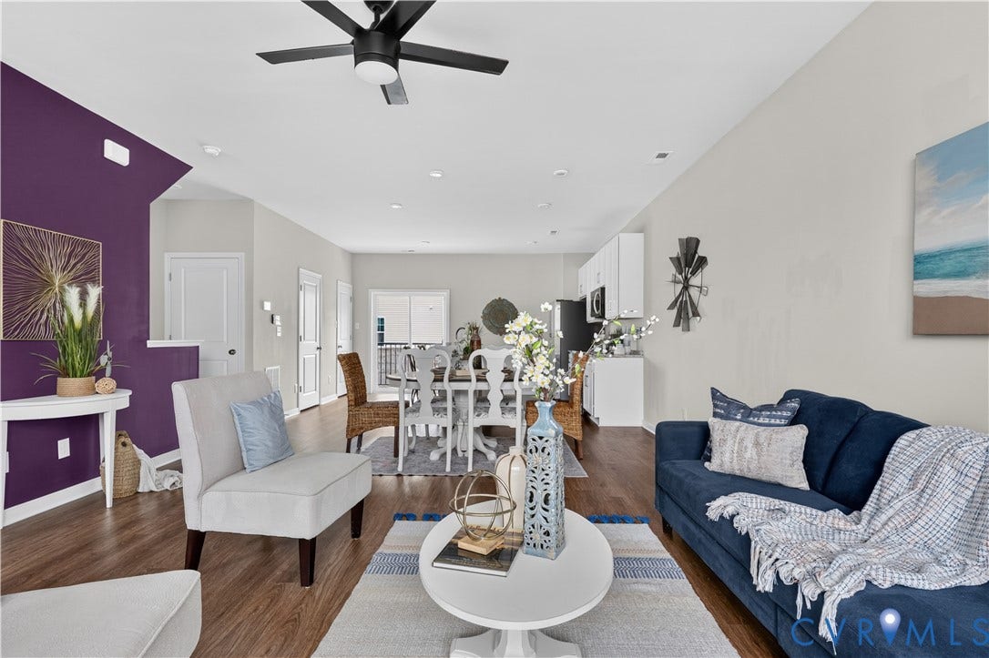Open-concept living space with wood-finish flooring, a contemporary ceiling fan, and recessed lighting