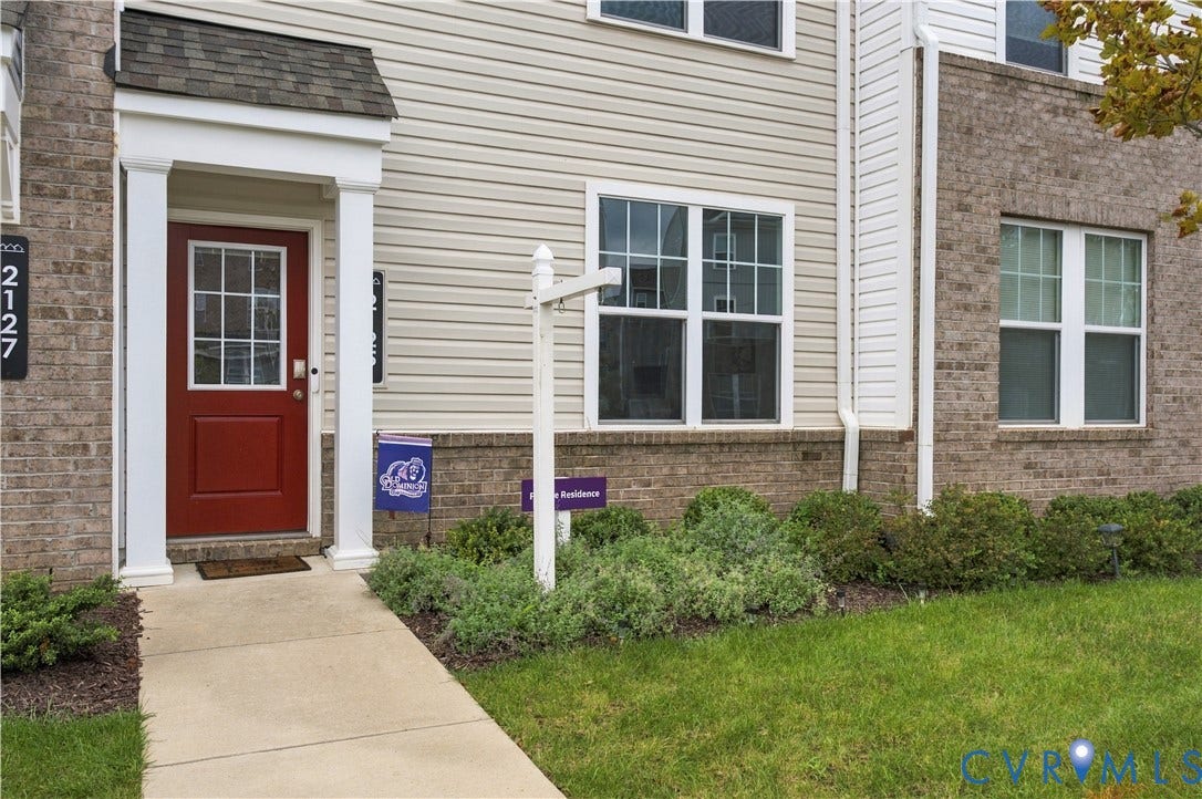 Brick and siding exterior with white window frames