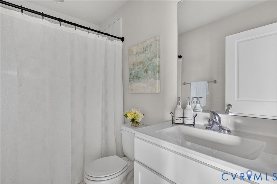 Integrated vanity with an undermount sink, chrome faucet, and expansive mirror