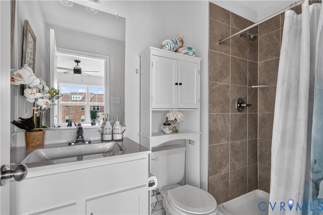 White vanity with an integrated sink and chrome faucet