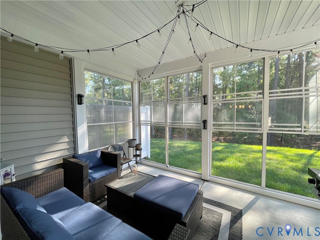 6905 Leire Lane, Chesterfield, VA 23832 Screened-in porch featuring a vaulted white paneled ceiling, durable concrete flooring, and multiple window panels