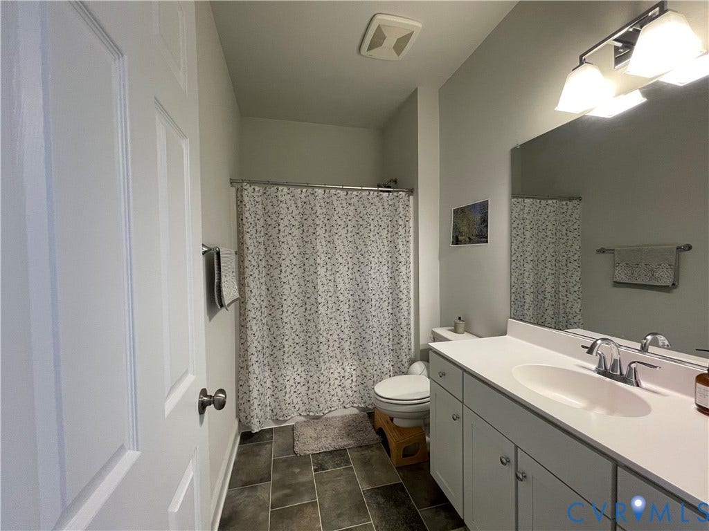 6905 Leire Lane, Chesterfield, VA 23832 White vanity with dual-door cabinetry, integrated sink, and chrome faucet