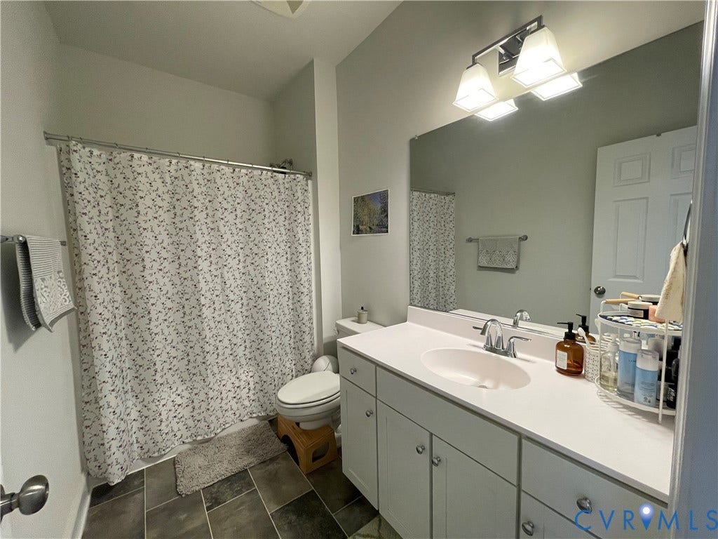 6905 Leire Lane, Chesterfield, VA 23832 Full vanity with an integrated sink, polished chrome faucet, and ample storage