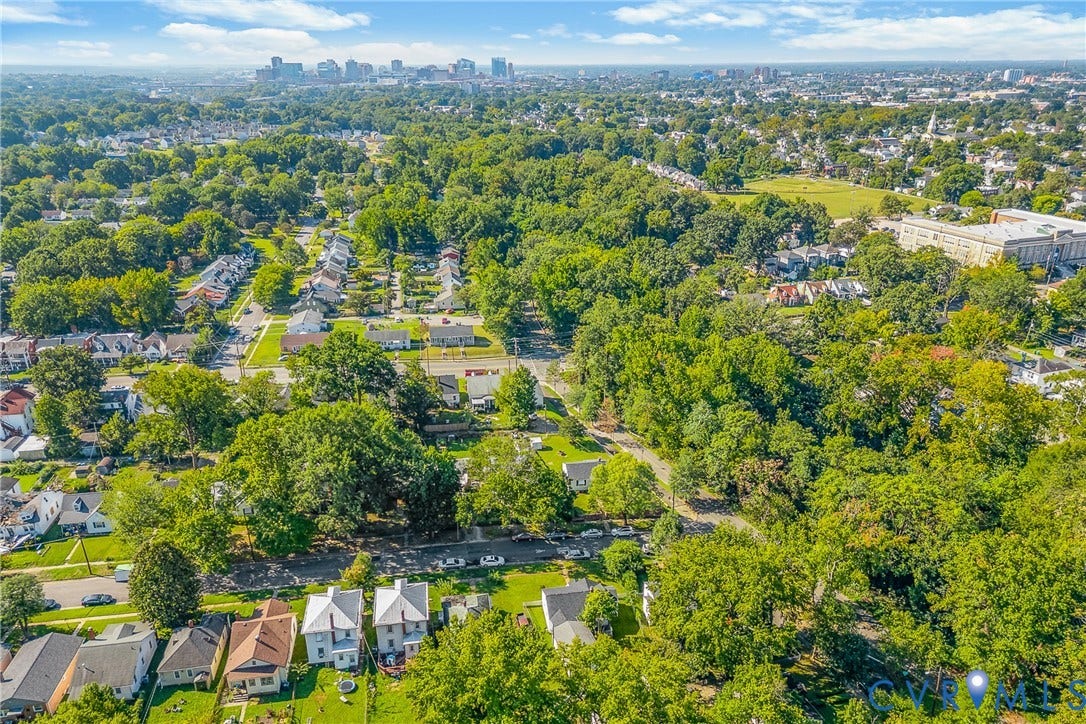 Aerial perspective of a residential neighborhood with mature tree coverage