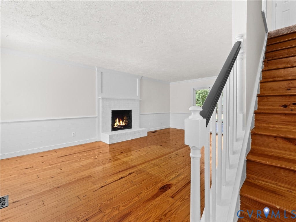 4504 Heritage Woods Lane, Heritage Woods, Midlothian, VA 23112 As you enter the front door, youre greeted by gorgeous knotty pine floors, custom shiplap accents, hardwood stairs, and a cozy brick wood-burning fireplace that adds warmth and character to the space.