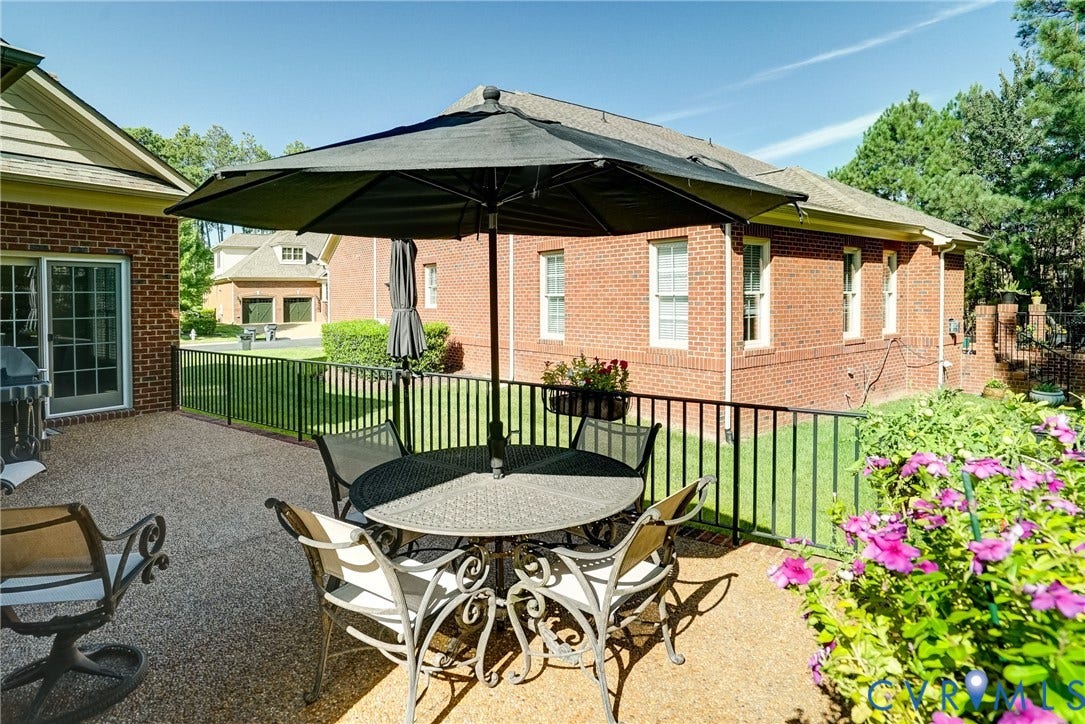 4938 Grey Oaks Villas Drive, Glen Allen, VA 23059 Expansive outdoor patio with a textured surface, surrounded by a black metal railing