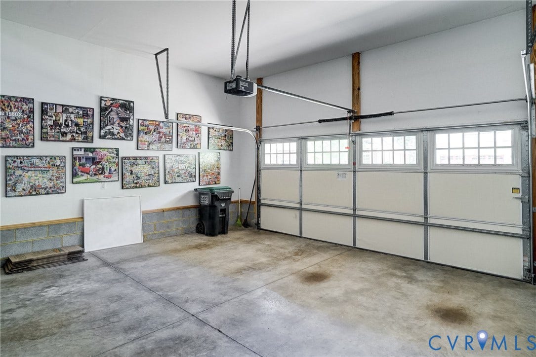 4938 Grey Oaks Villas Drive, Glen Allen, VA 23059 Garage space featuring a concrete floor, white walls, and an automatic garage door opener