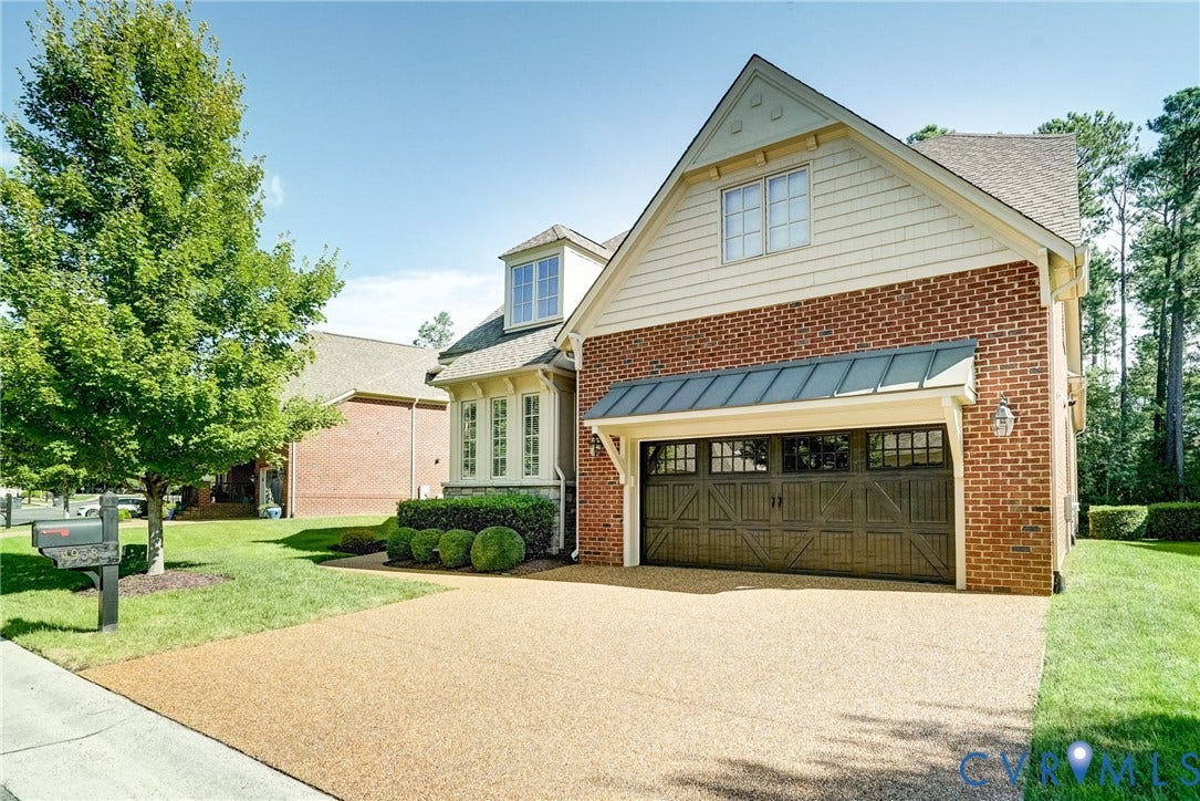 4938 Grey Oaks Villas Drive, Glen Allen, VA 23059 Brick exterior with siding accents, attached garage with decorative doors, dormer window, bay window, and manicured landscaping