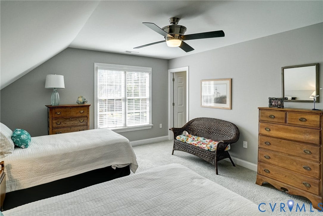 4938 Grey Oaks Villas Drive, Glen Allen, VA 23059 Sloped ceiling design, ceiling fan with integrated lighting, light gray wall paint, white window trim, and wall-to-wall carpeting