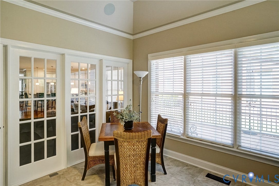 4938 Grey Oaks Villas Drive, Glen Allen, VA 23059 Vaulted ceiling with an integrated speaker, extensive crown molding, three large windows, and a tiled floor