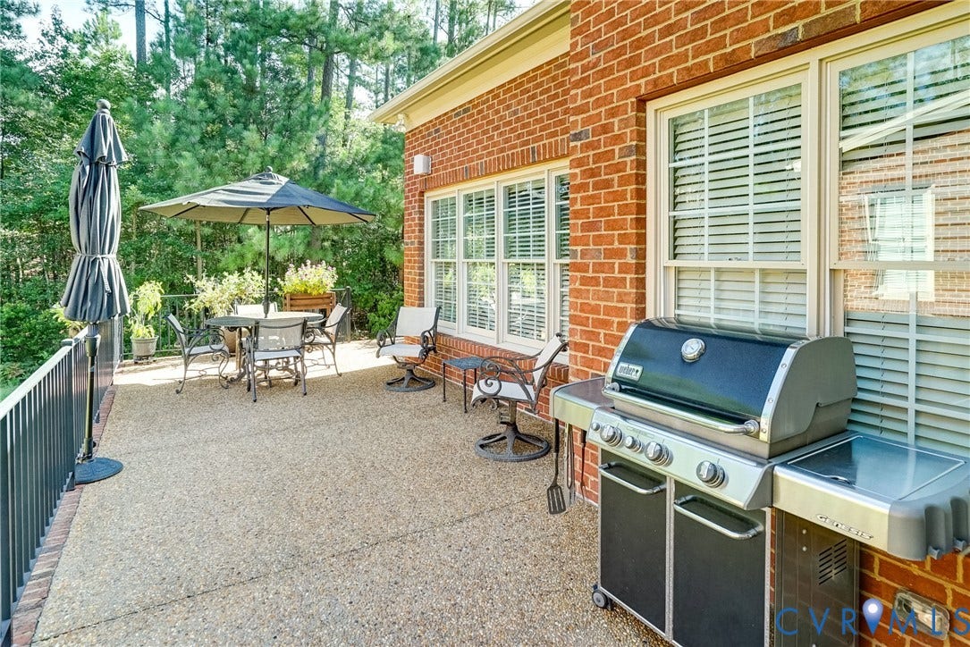 4938 Grey Oaks Villas Drive, Glen Allen, VA 23059 Brick exterior with multiple windows, exposed aggregate patio, and metal railing