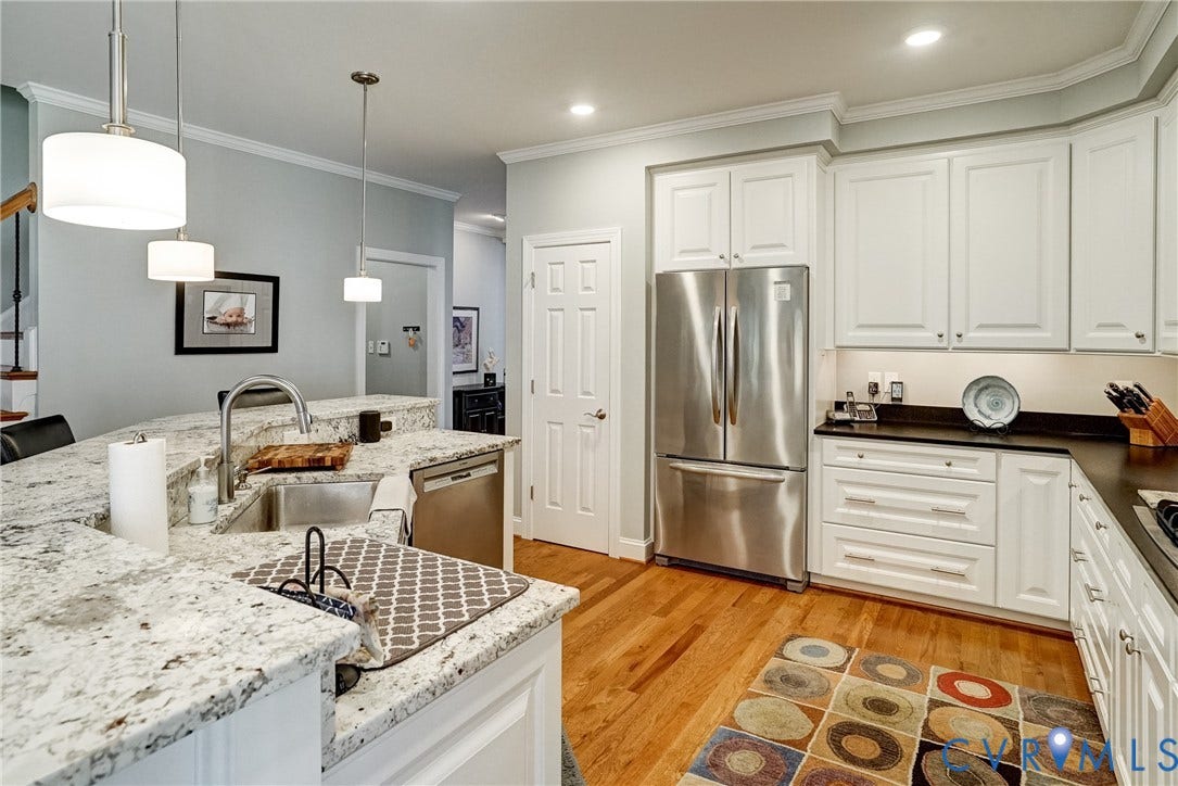 4938 Grey Oaks Villas Drive, Glen Allen, VA 23059 Kitchen featuring white cabinetry, stainless steel appliances, light-toned countertops, hardwood flooring, and recessed lighting