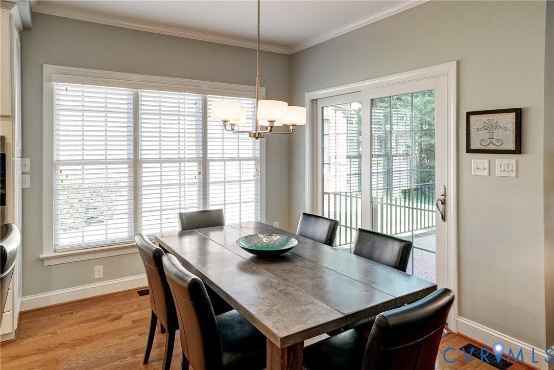 4938 Grey Oaks Villas Drive, Glen Allen, VA 23059 Hardwood flooring, crown molding, white trim, sliding glass door, and a multi-light chandelier