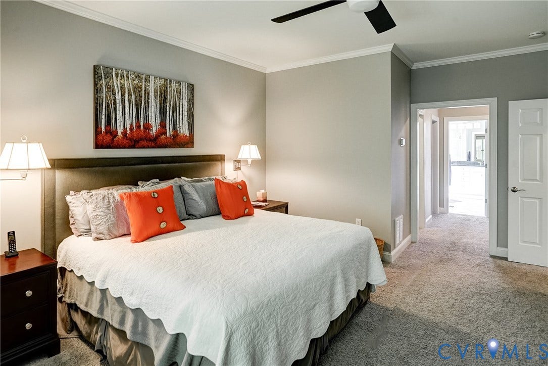 4938 Grey Oaks Villas Drive, Glen Allen, VA 23059 Carpeted room featuring a built-in upholstered headboard, white trim, and a ceiling fan