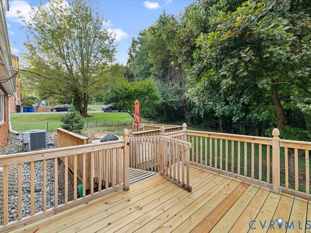 4630 Melody Court, Meadowbrook West, North Chesterfield, VA 23234 Expansive wood deck with natural wood railings, featuring a split-level design and a gate