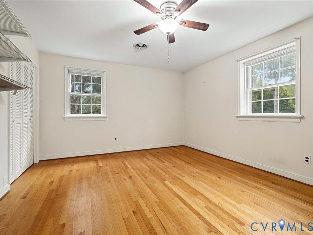 4630 Melody Court, Meadowbrook West, North Chesterfield, VA 23234 Bedroom 3 Hardwood flooring, two large windows, ceiling fan with integrated lighting, built-in shelving, and louvered bifold doors